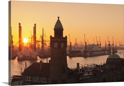 St. Pauli Landungsbruecken pier against harbour at sunset, Hamburg, Germany