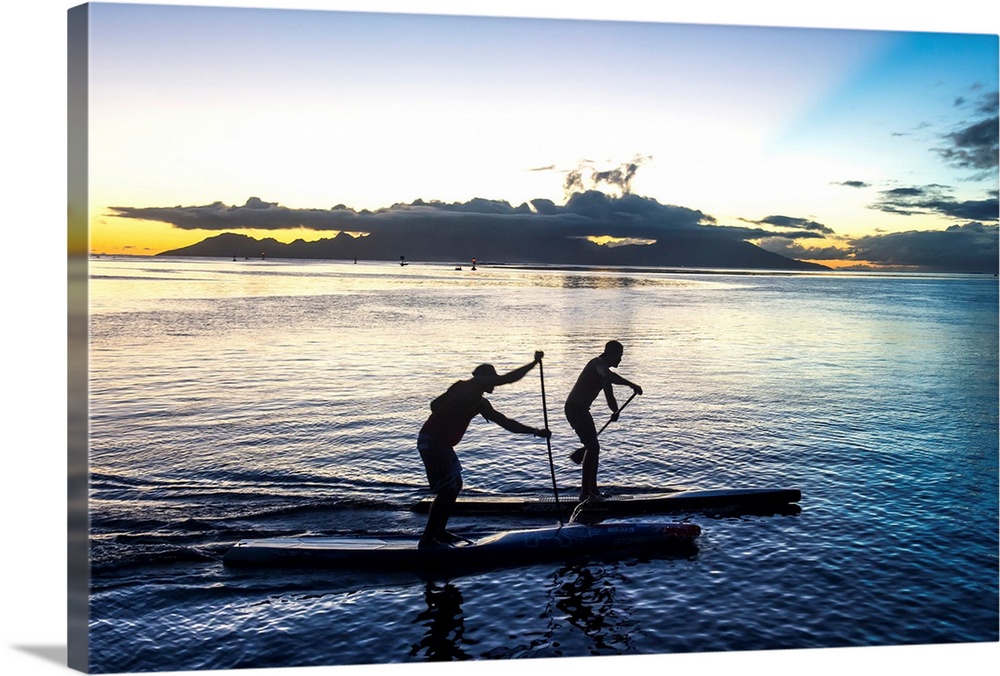 Stand up paddlers working out at sunset with Moorea in the background, Papeete, Tahiti, Society Islands, French Polynesia