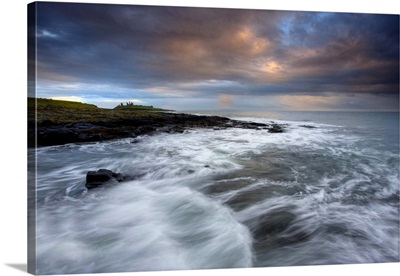 Stormy day with ruins of Dunstanburgh Castle, Northumberland, England