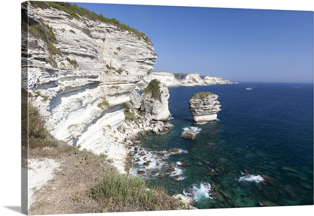 Sun shines on the white limestone cliffs framed by the turquoise sea, Bonifacio, Corsica, France