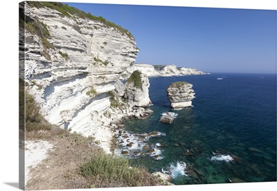 Sun shines on the white limestone cliffs framed by the sea, Bonifacio, Corsica, France