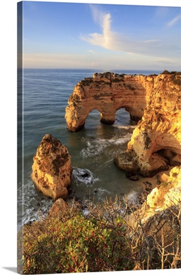 Sunrise on cliffs framed by turquoise water of the ocean, Algarve, Portugal