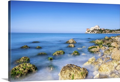 Sunrise on turquoise sea frames the medieval Falconara Castle, Sicily, Italy