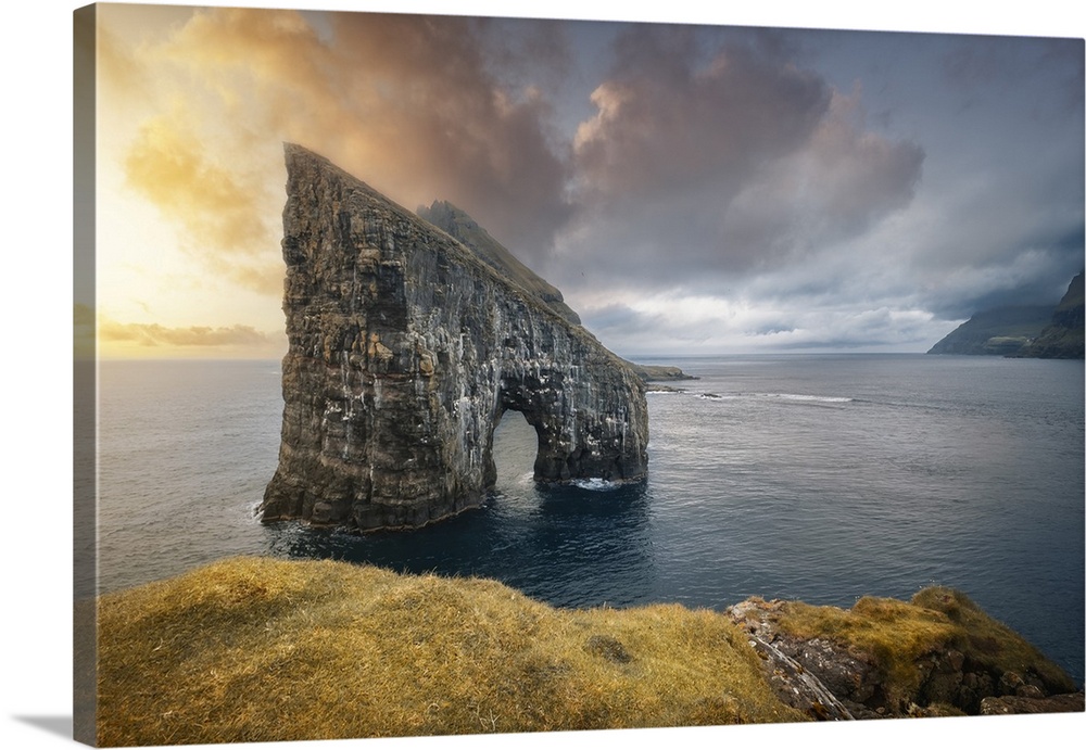 Sunset at Drangarnir, the famous sea stack in Vagar island, Faroe Islands, Denmark, North Atlantic, Europe