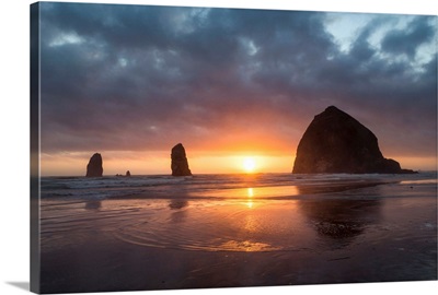 Sunset behind Haystack Rock at Cannon Beach on the Pacific Northwest coast, Oregon