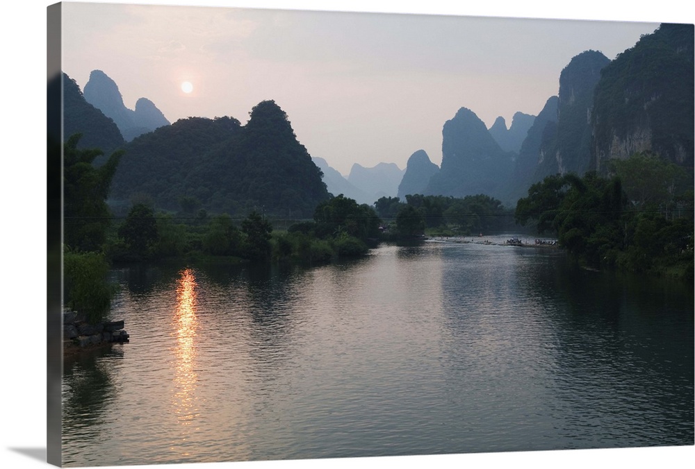 Sunset over karst limestone scenery on the Li river in Yangshuo, China