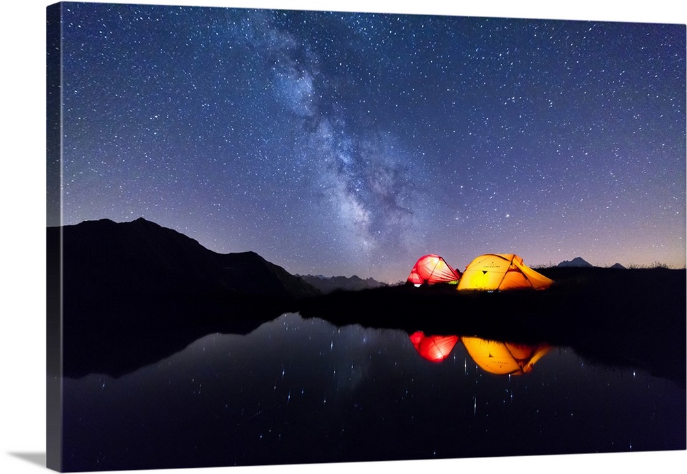 Tents reflected in the alpine lake on a starry night, Mont De La Saxe, Courmayeur, Aosta Valley, Italy