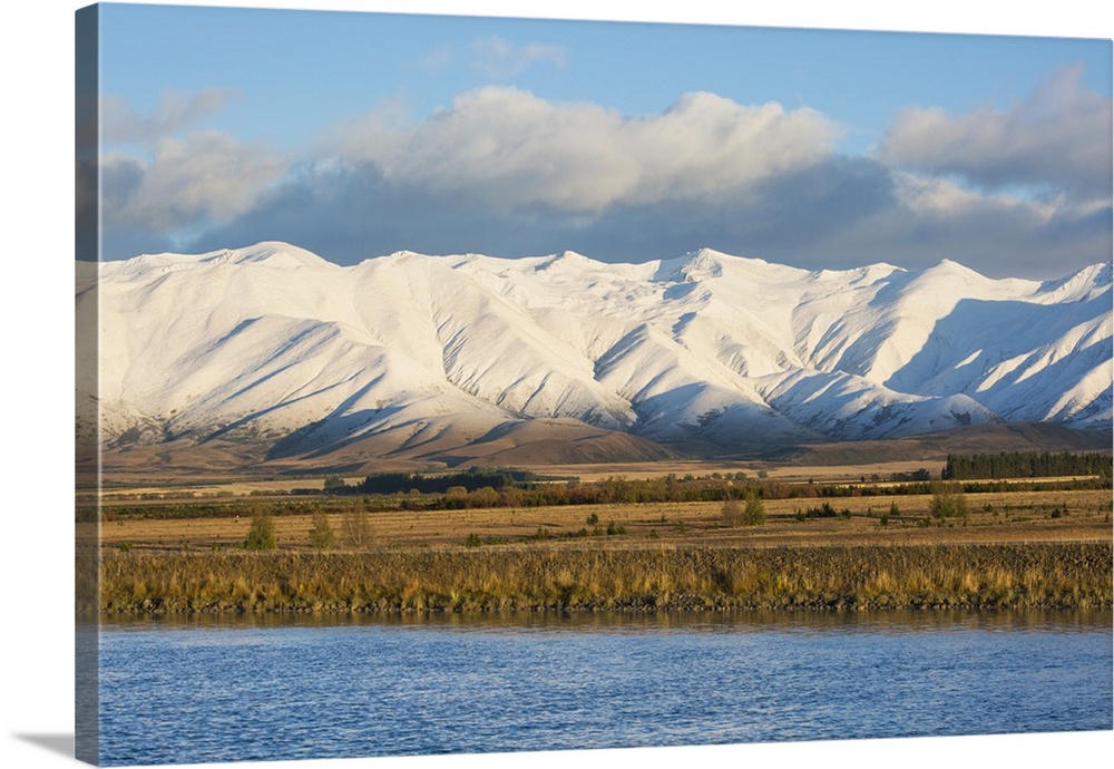 The Ben Ohau Range cloaked in autumn snow, the Pukaki Canal in foreground, Twizel, Mackenzie district, Canterbury, South I...