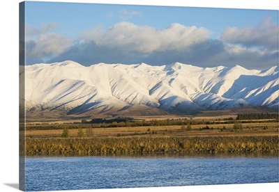 The Ben Ohau Range cloaked in autumn snow, the Pukaki Canal in foreground