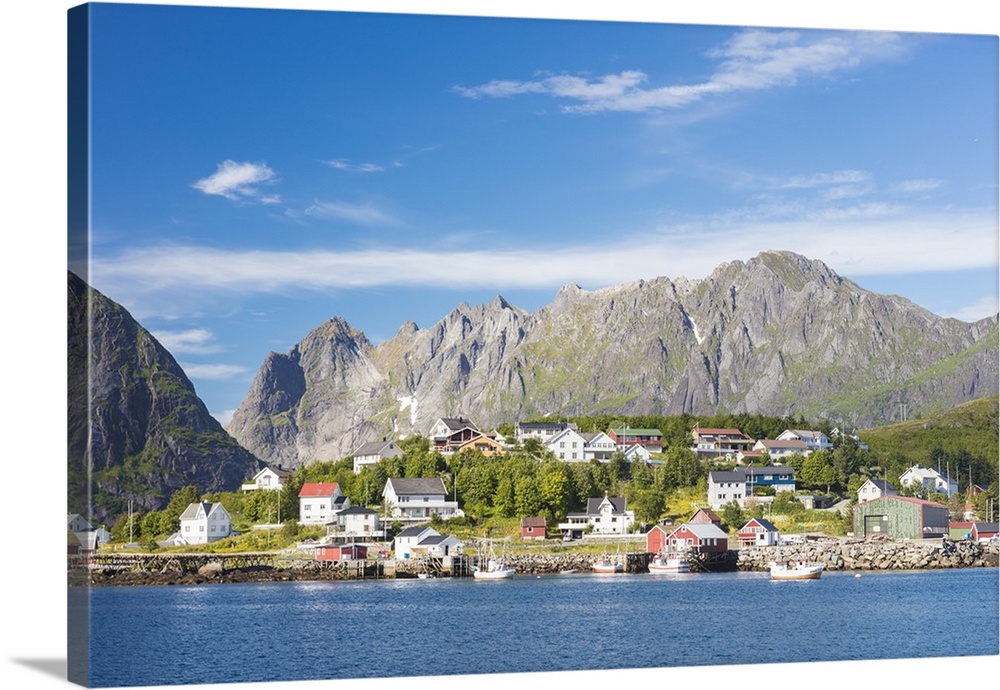 The blue sea frames the fishing village and the rocky peaks, Reine, Moskenesoya, Lofoten Islands, Norway, Scandinavia, Europe
