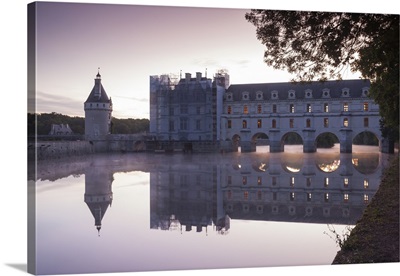 The chateau of Chenonceau reflecting in the waters of the River Cher at dawn, France