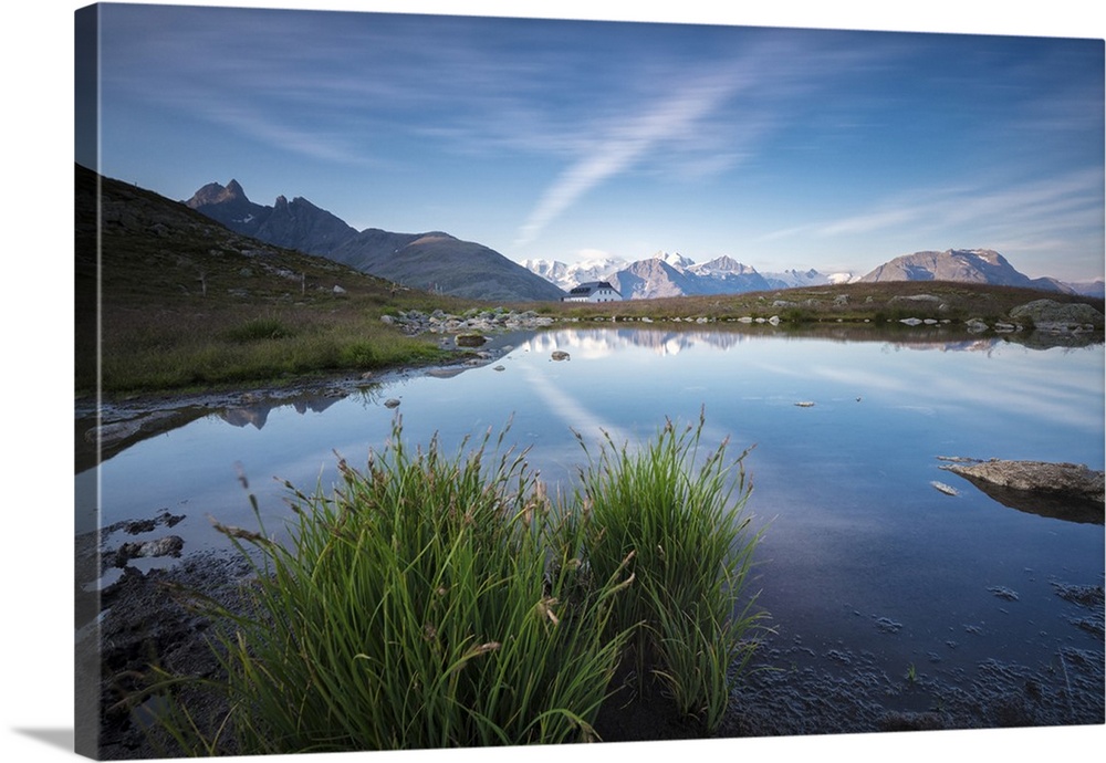 The clear sky is reflected in the blue alpine lake, Muottas Muragl, Samedan, Canton of Graubunden, Engadine, Switzerland
