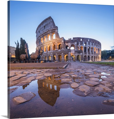 The Colosseum, reflected in a puddle at dusk, Rome, Lazio, Italy