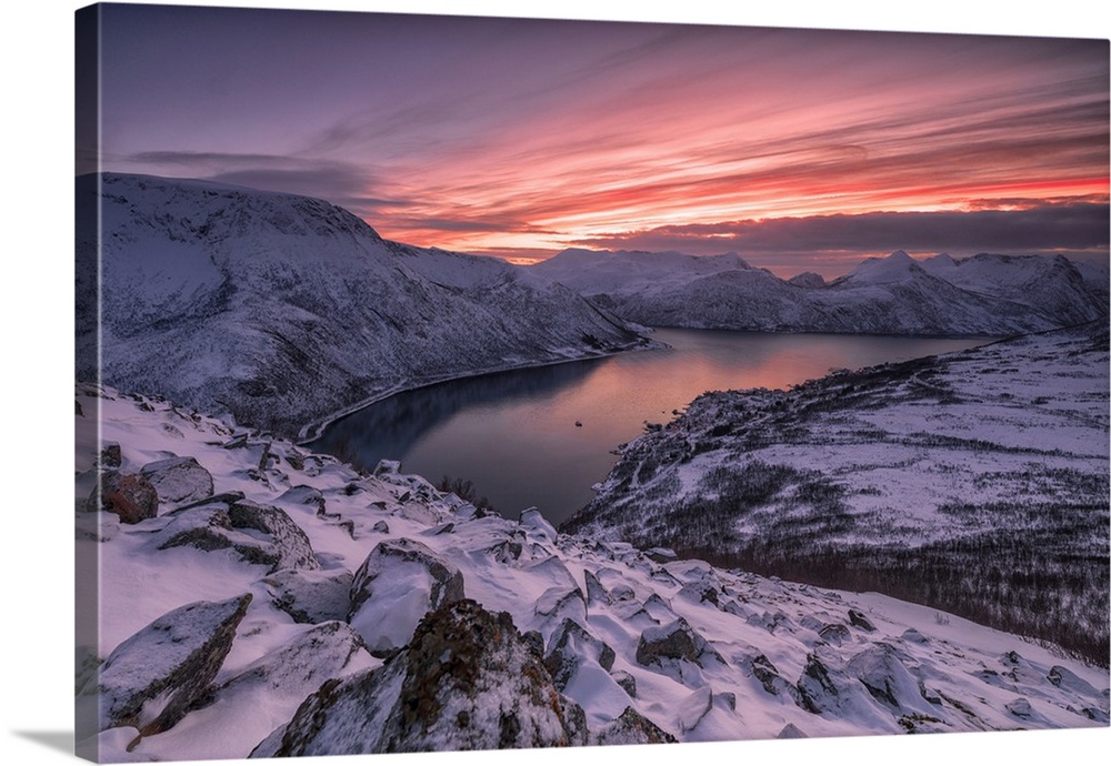 The frozen sea surrounded by snow framed by pink clouds, Arctic, Norway, Scandinavia, Europe