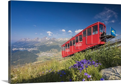 The funicular railway runs across the alpine meadows, Samedan, Switzerland