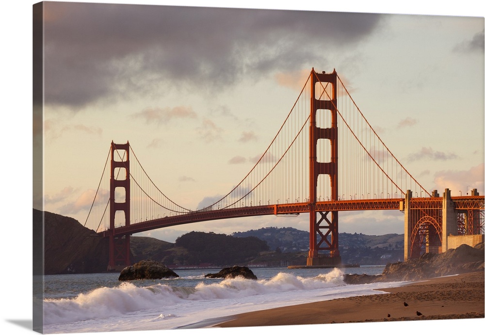 The Golden Gate Bridge, linking the city of San Francisco with Marin County, taken from Baker Beach at sunset and high tid...