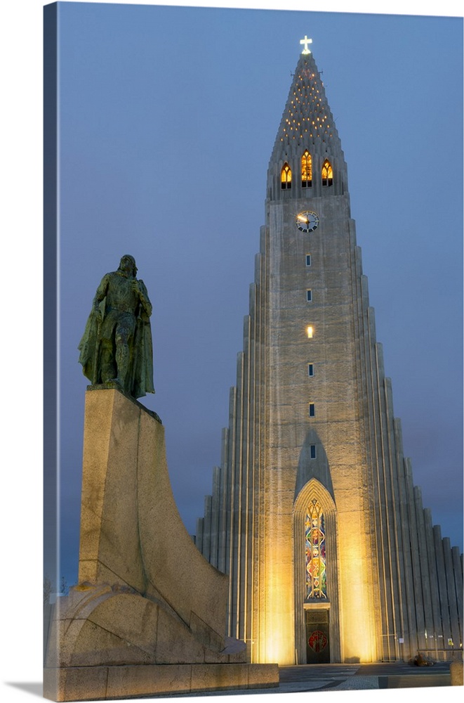 The Hallgrims Church with a statue of Leif Erikson in the foreground lit up at night, Reykjavik, Iceland, Polar Regions