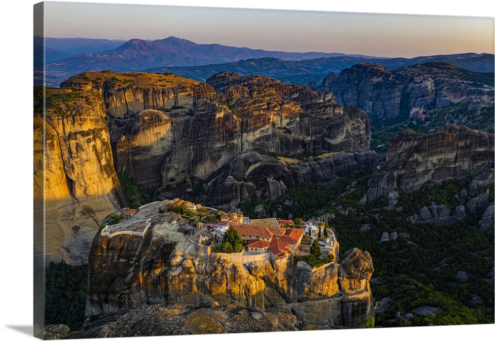 Aerial by drone of the Holy Monastery of Holy Trinity at sunrise, UNESCO World Heritage Site, Meteora Monasteries, Greece,...