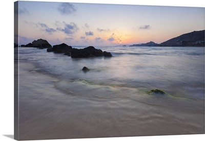 The last lights of the sunset are reflected on sea waves, Licata, Sicily, Italy