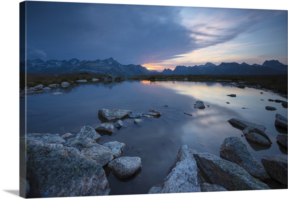 The lights of sunrise reflected in the alpine lake, Muottas Muragl, Samedan, Canton of Graubunden, Engadine, Switzerland