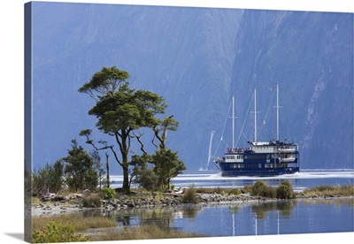The Milford Mariner dwarfed by steep mountains, New Zealand