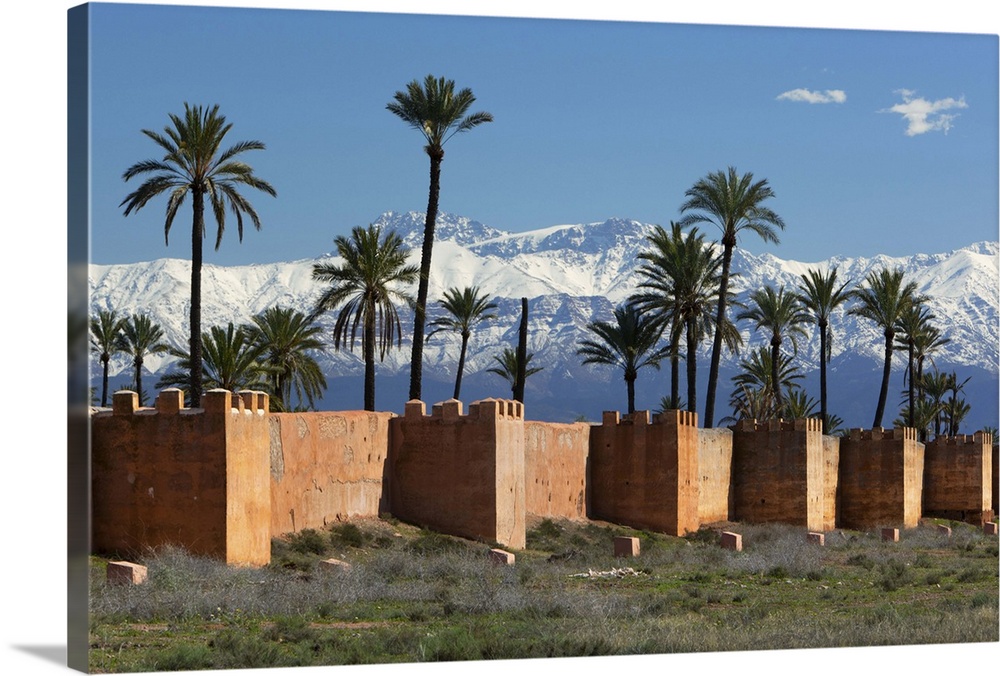 The old city walls and snow capped Atlas Mountains, Marrakech, Morocco, North Africa, Africa.