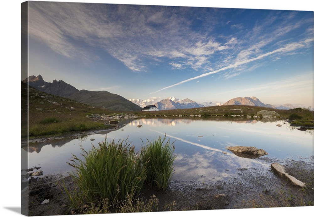 The clear sky is reflected in the blue alpine lake, Muottas Muragl, Samedan, Canton of Graubunden, Engadine, Switzerland