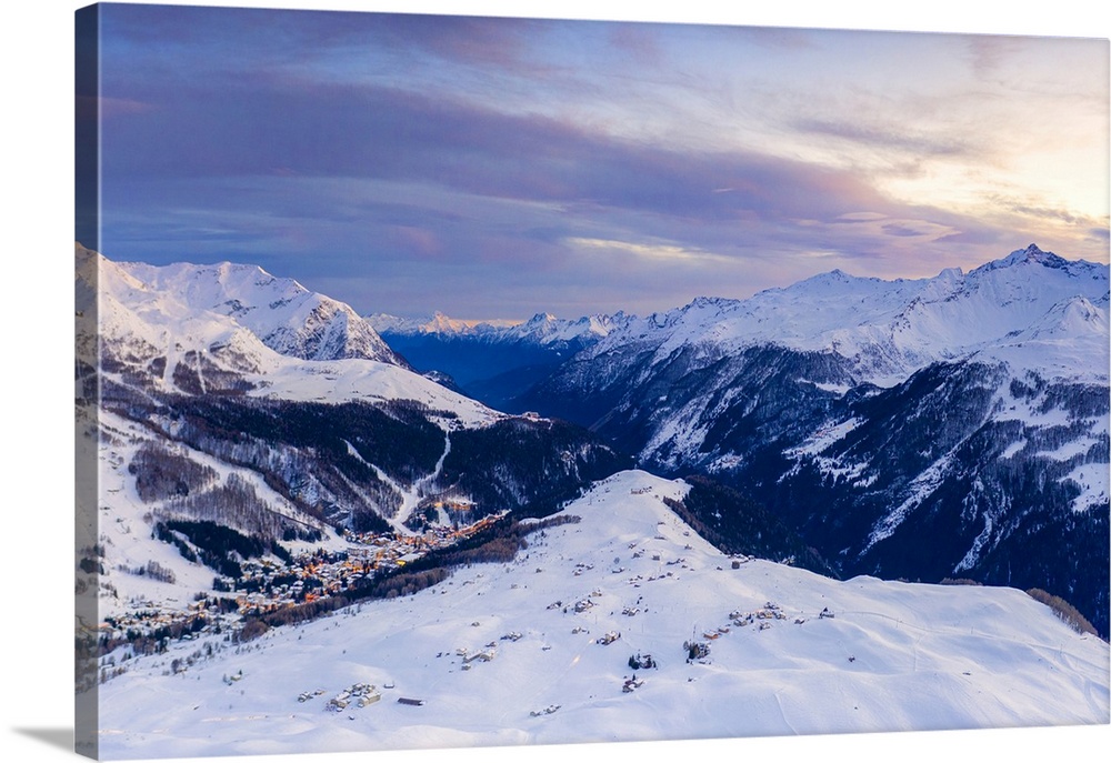 Aerial view by drone of sunset on the snowy peaks surrounding Madesimo and Andossi, Valchiavenna, Valtellina, Lombardy, It...