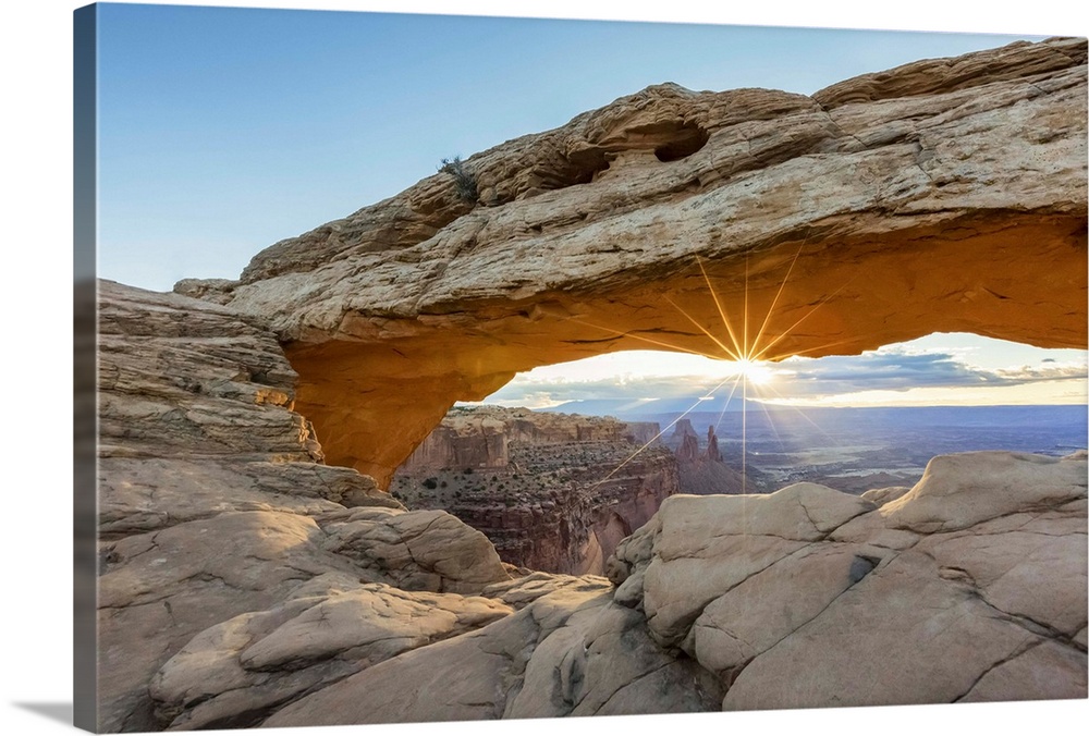 The sun is rising under Mesa Arch, Canyonlands National Park, Moab, Utah, United States of America, North America