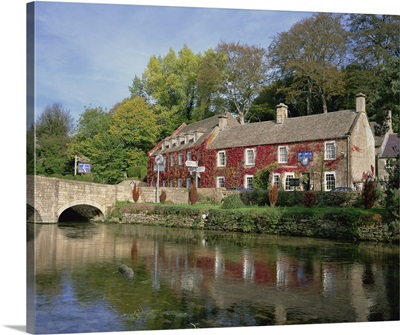 The Swan Hotel reflected in the river at Bibury, Gloucestershire, England