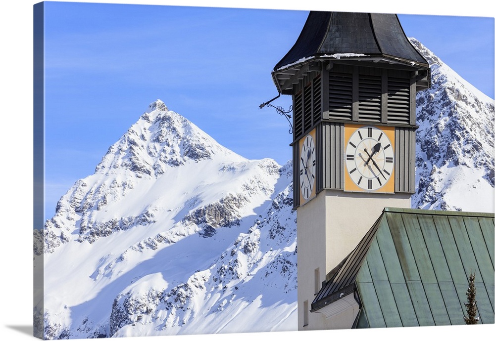 The typical alpine bell tower frames the snowy peaks, Langwies, district of Plessur, Canton of Graubunden, Swiss Alps, Swi...