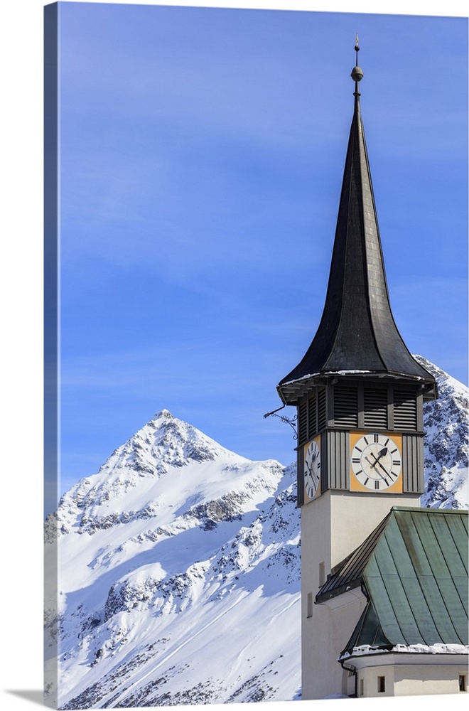 The typical alpine bell tower frames the snowy peaks, Langwies, district of Plessur, Canton of Graubunden, Swiss Alps, Swi...
