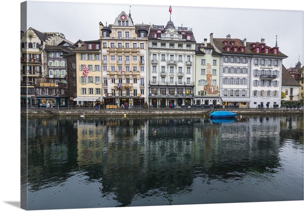 The typical buildings of the old medieval town are reflected in River Reuss, Lucerne, Switzerland, Europe