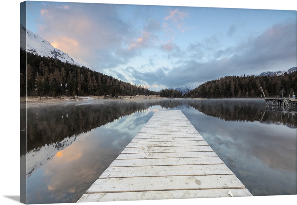 The wooden deck frames Lej Da Staz at dawn, St. Moritz, Canton of Graubunden, Engadine, Switzerland, Europe