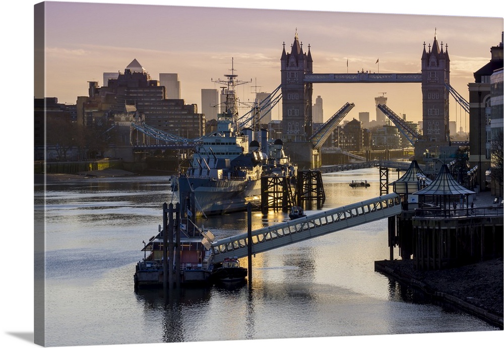 Tower Bridge raising deck with HMS Belfast on the River Thames, London, England