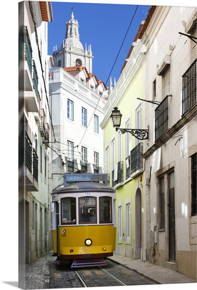 Tram along Rua das Escolas Gerais with tower of Sao Vicente de Fora, Lisbon, Portugal