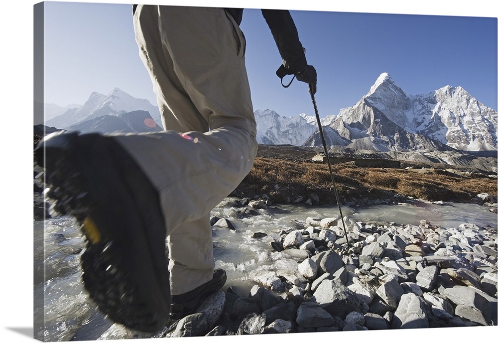 Trekker crossing a mountain stream, Ama Dablam, 6812m, Solu Khumbu Everest Region, Sagarmatha National Park, Himalayas, Ne...