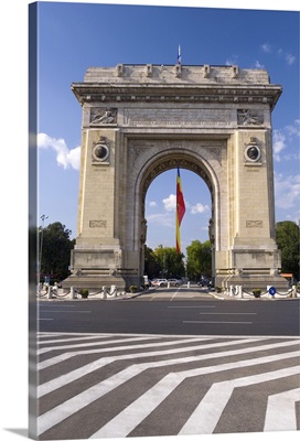 Triumphal Arch (Arcul de Triumf) and Romanian flag, Bucharest, Romania