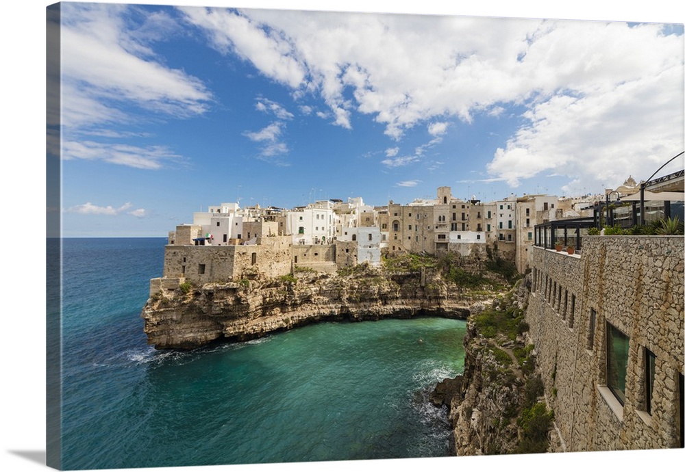 Turquoise sea framed by the old town perched on the rocks, Polignano a Mare, Province of Bari, Apulia, Italy