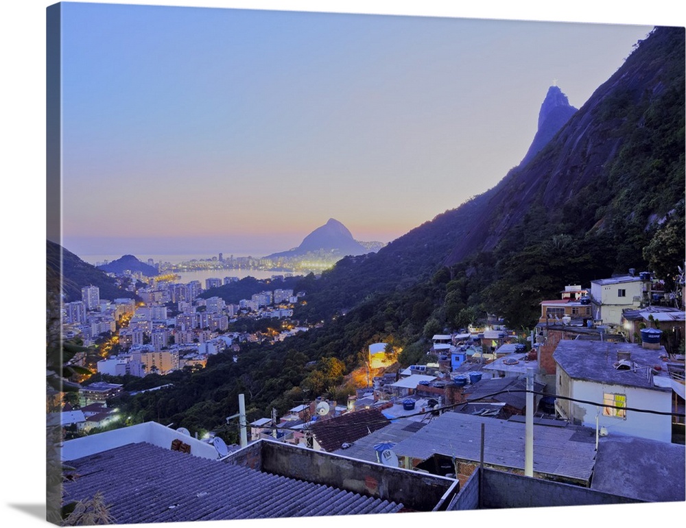 Twilight view of the Favela Santa Marta with Corcovado and the Christ statue behind, Rio de Janeiro, Brazil, South America