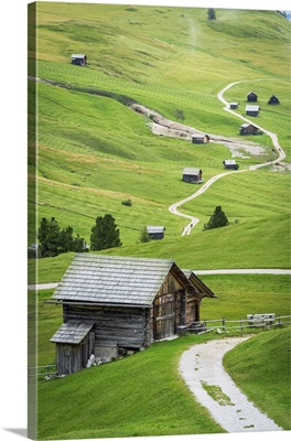 Typical Alpine Wooden Mountain Huts On Green Fields, Dolomites, Italy
