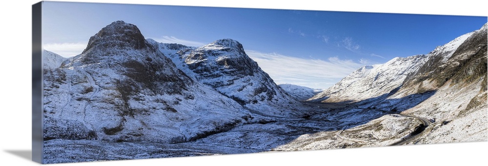 View down snow-covered Glencoe showing Three Sisters of Glencoe, Scotland