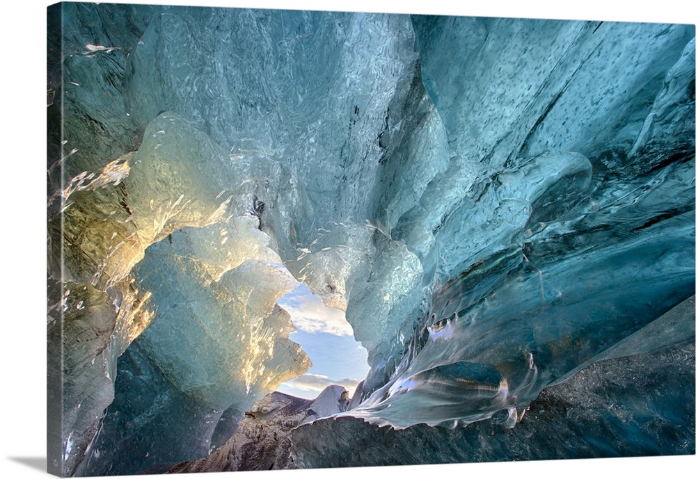 View inside an ice cave under the south  Vatnajokull Glacier, captured at sunrise during winter when the ice caves are acc...