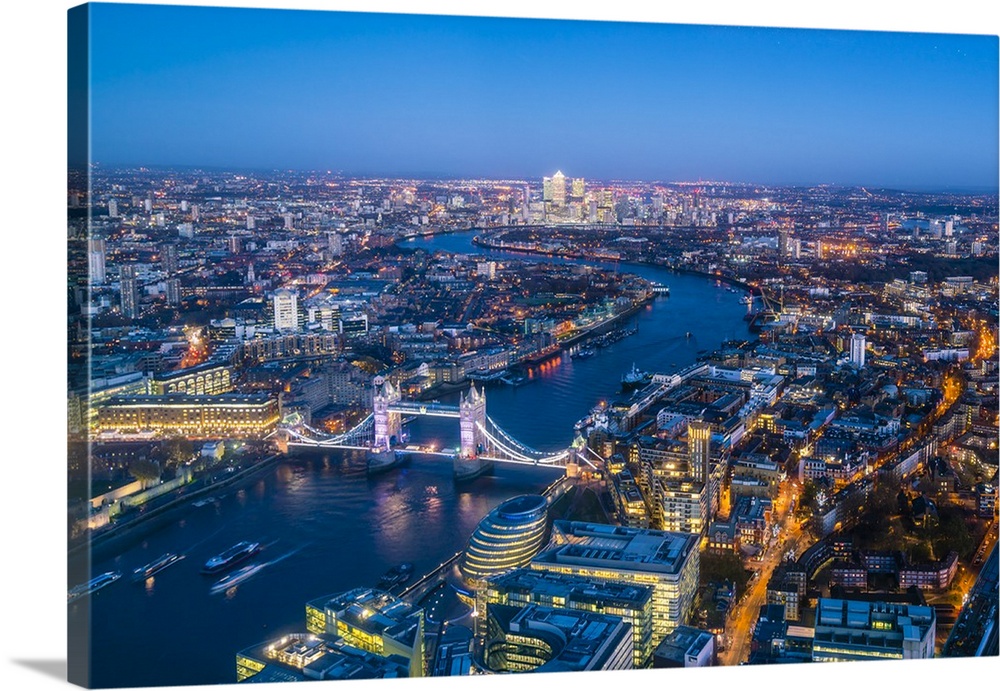 High view of London skyline at dusk along the River Thames from Tower Bridge to Canary Wharf, London, England, United King...