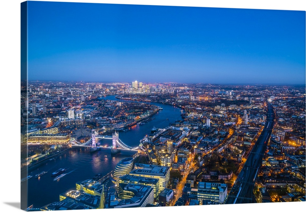High view of London skyline at dusk along the River Thames from Tower Bridge to Canary Wharf, London, England, United King...