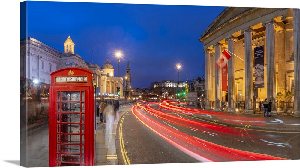View of red telephone box and Trafalgar Square at dusk, Westminster, London, England, United Kingdom, Europe