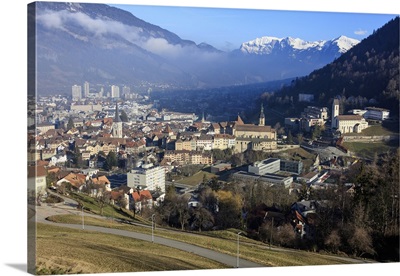 View of the city of Chur surrounded by woods and snowy peaks, Switzerland