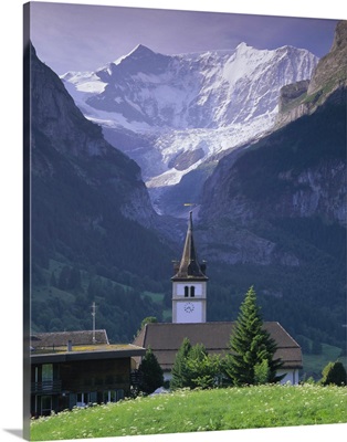 Village church and Oberer Grindelwald Glacier, Swiss Alps, Switzerland