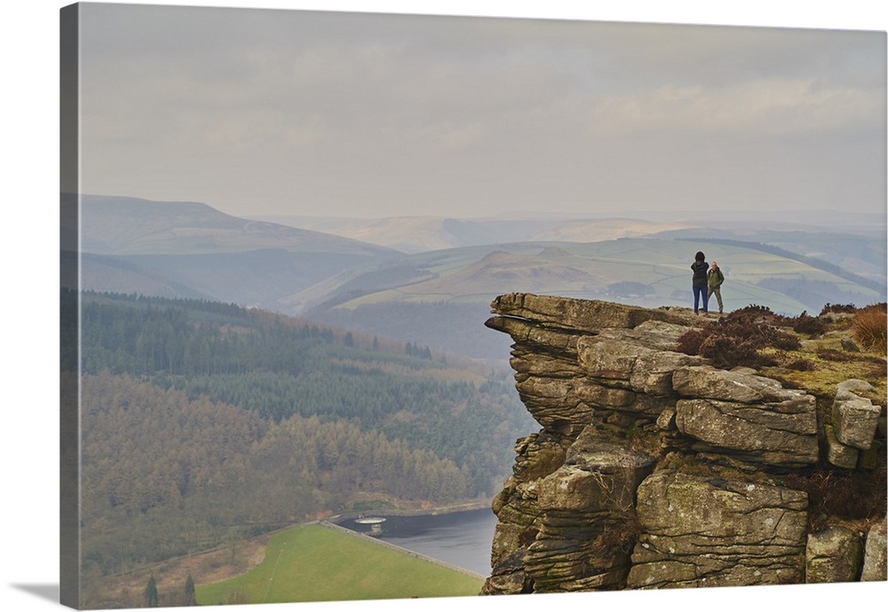Walkers taking in the view on Hathersage Edge, Ladybower Reservoir below, Peak District National Park, Derbyshire, England