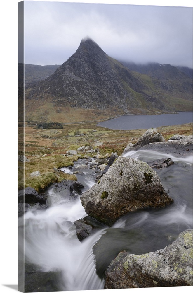 Water cascading down a fall on the Afon Lloer, overlooking the Ogwen Valley and Tryfan in the Glyderau mountain range, Sno...